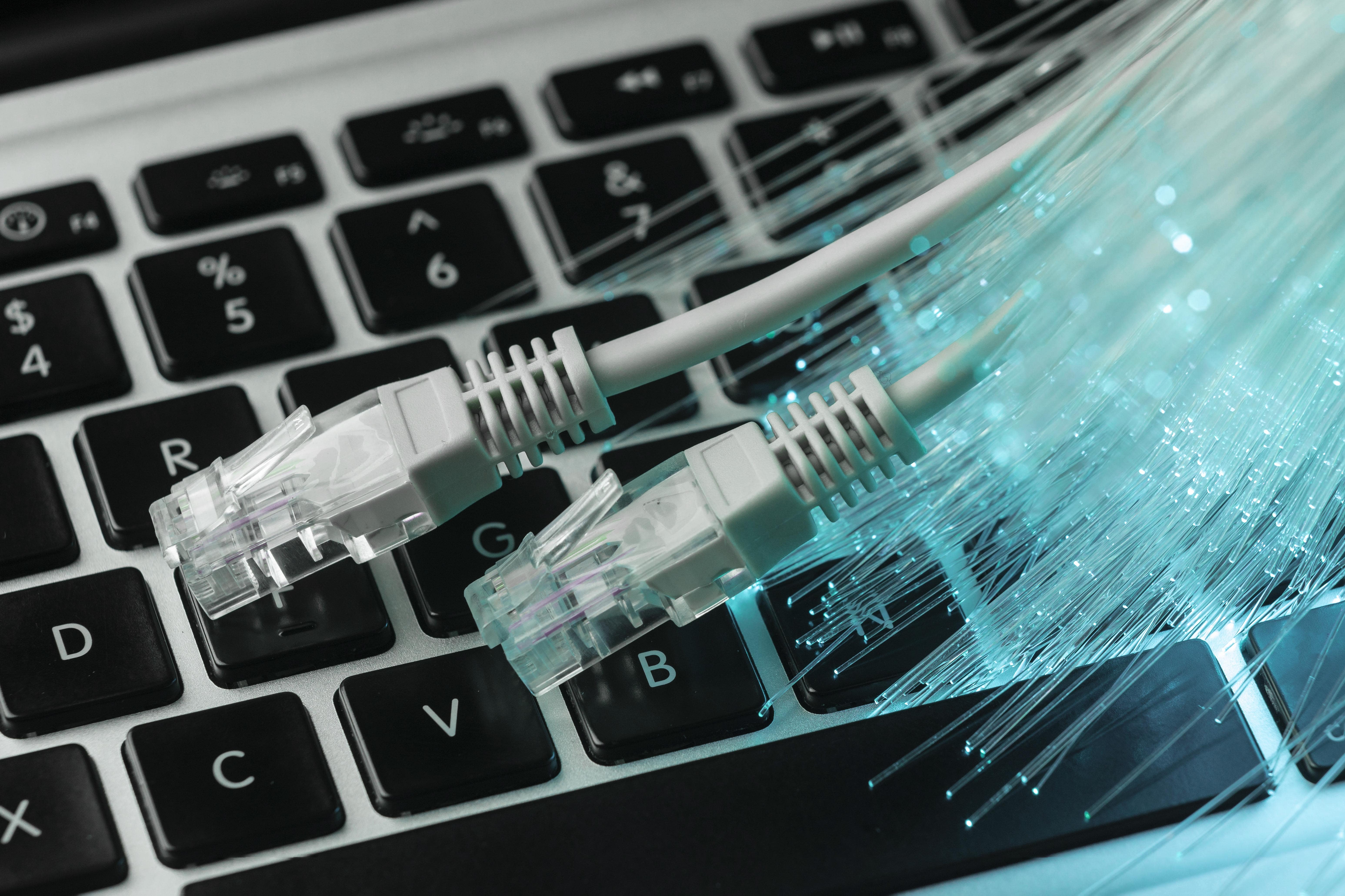 blue-optic-fiber-with-ethernet-cables-laptop-min
